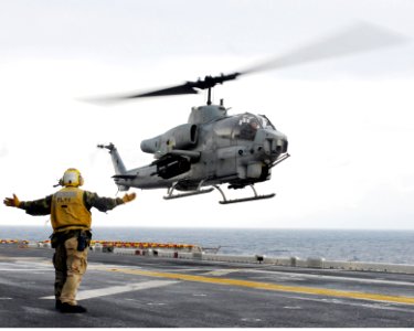 US Navy 090127-N-9950J-089 Aviation Boatswain's Mate (Handling) 3rd Class Jeffrey Baker, from Davenport, Iowa, directs the landing of an AH-1Z Super Cobra attack helicopter