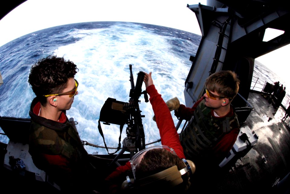 US Navy 090124-N-8157C-071 Aviation Ordnanceman 3rd Class Joshua Hagerty, left, from Philadelphia, Mo., and Gunner's Mate 2nd Class Marshall Dunn, right, from Redding, Calif., assist weapons department personnel in reloading an