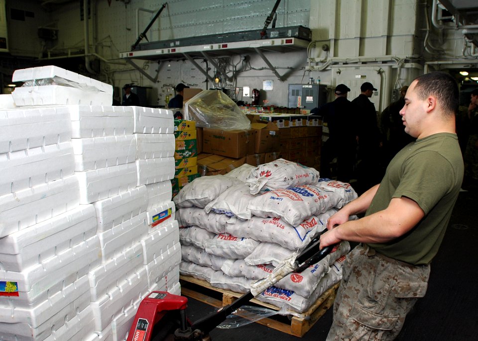US Navy 090124-N-5681S-029 Cpl. Benjamin Chavez loads supplies aboard the multi-purpose amphibious assault ship USS Iwo Jima (LHD 7)