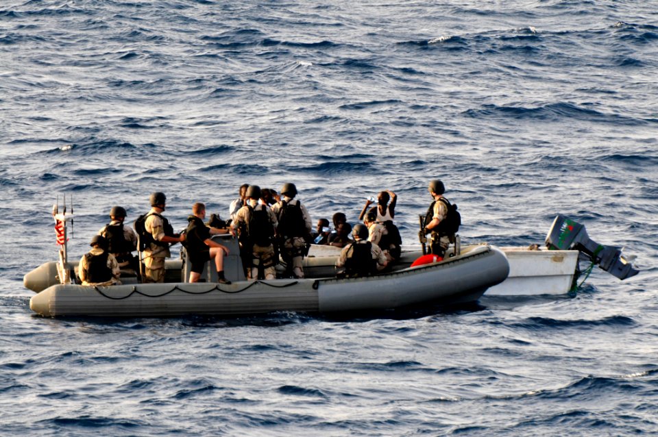 US Navy 110812-N-YM590-350 Members of a visit, board, search and seizure team from the guided-missile cruiser USS Anzio (CG 68) assist mariners abo
