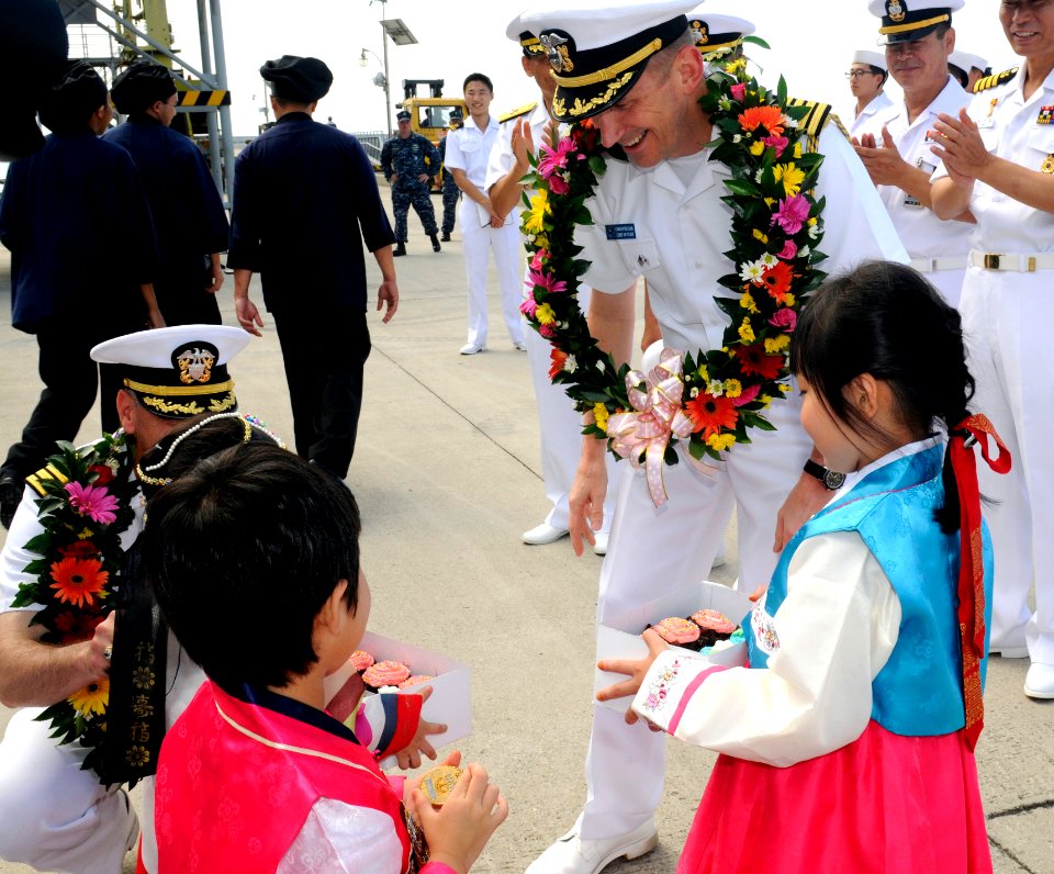 US Navy 110813-N-DB801-370 Capt. Charles Williams, U.S. 7th Fleet Chief of Staff, receives cupcakes from Korean children