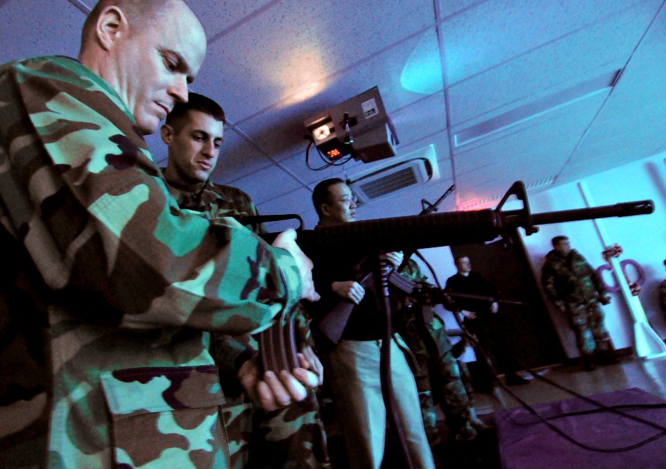 US Navy 090129-N-0807W-112 Sailors reload laser-emitting M16 rifle simulators during the grand opening of the indoor weapons training facility at Fleet Activities Sasebo