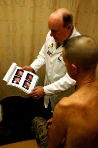 US Navy 090126-N-6326B-241 Orthopedic surgeon Capt. Dana Covey, chairman of Orthopedic Surgery at Naval Medical Center San Diego, explains an injury to a patient
