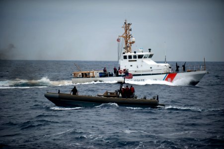 US Navy 110820-N-PB383-334 Sailors from the USS New Orleans turn over suspected drugs to the Coast Guard