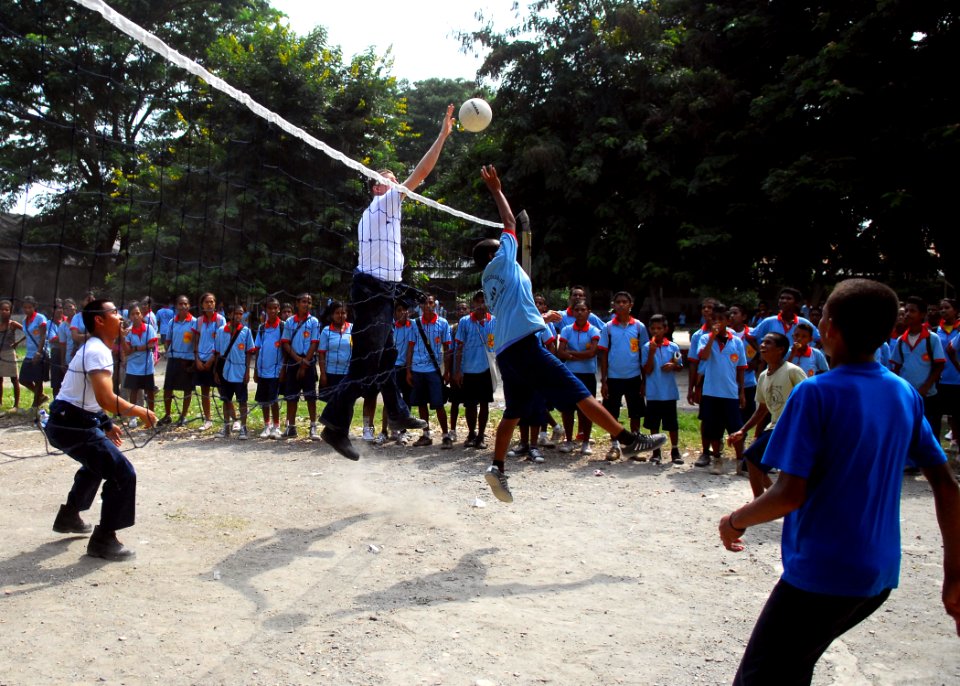 US Navy 090127-N-2013O-034 Hull Technician Fireman Vince Newell, from Detroit, assigned to the Arleigh Burke-class guided-missile destroyer USS Lassen (DDG 82), plays volleyball with students at the Comoro Intermediate School i