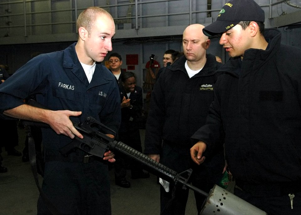 US Navy 090127-N-9134V-040 Gunner's Mate Seaman James Clarke monitors Seaman Jason Farkas as he clears the barrel of an M16 rifle during a weapons safety stand down
