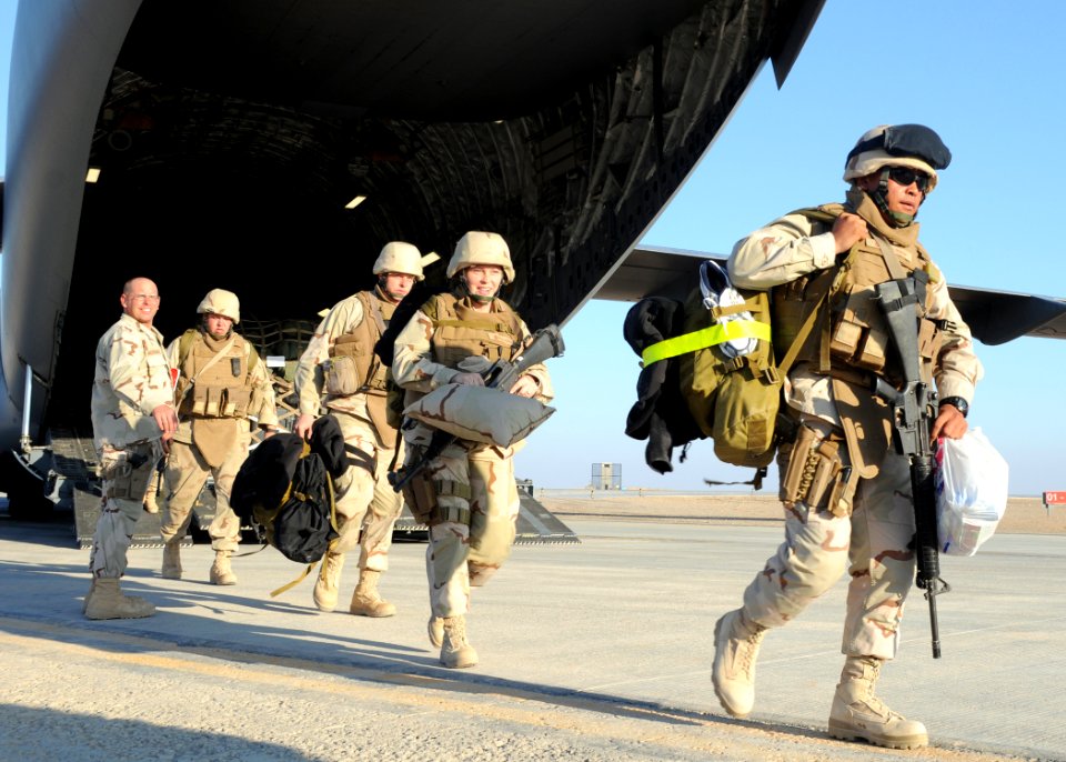 US Navy 090128-N-1120L-113 Seabees depart an Air Force C-17 aircraft