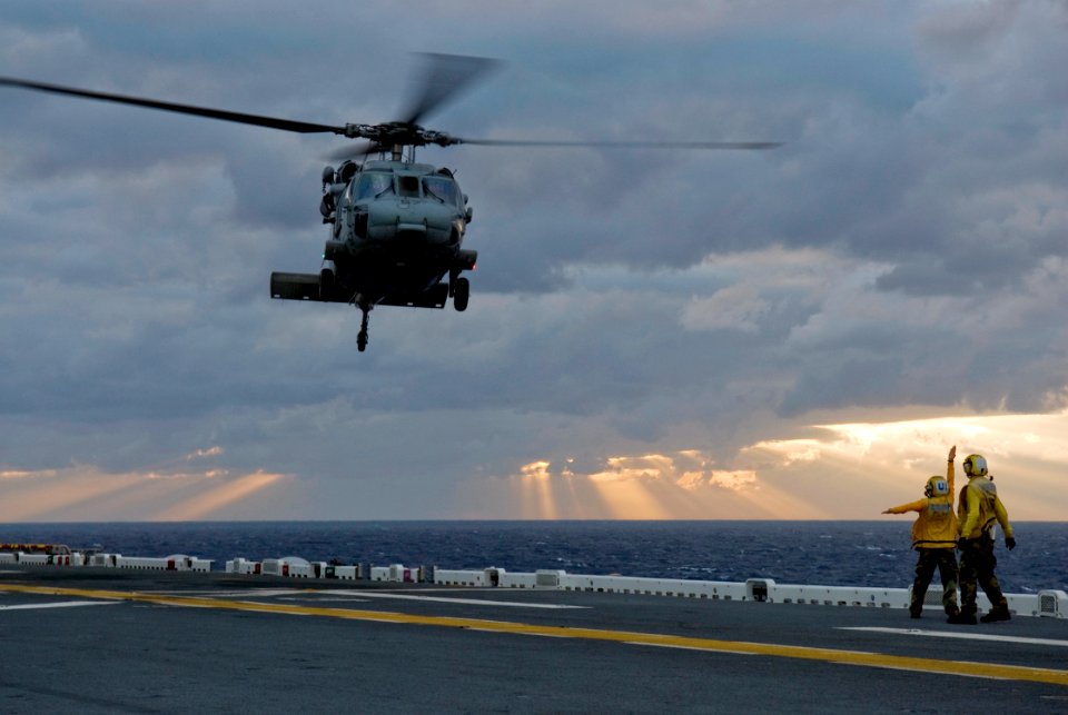 US Navy 090131-N-5253W-011 Aviation Boatswain's Mate (Handling) Airman Emerald Walton, from Salem, Ohio, directs an MH-60S Sea Hawk helicopter assigned to Sea Combat Helicopter Squadron (HSC) 25