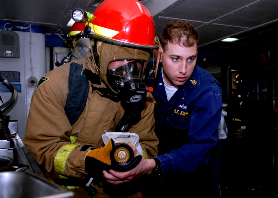 US Navy 090131-N-9520G-133 Senior Chief Damage Controlman Michael Kaszubowski, from Chicago, Ill., assigned to Afloat Training Group Western Pacific, advises a Sailor