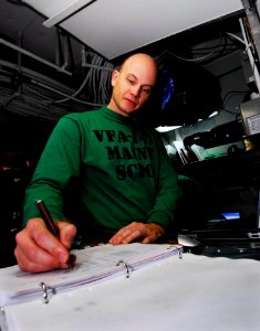 US Navy 090126-N-6538W-072 Senior Chief Aviation Electronics Technician Robert Armer, from New Orleans, verifies maintenance reports from the