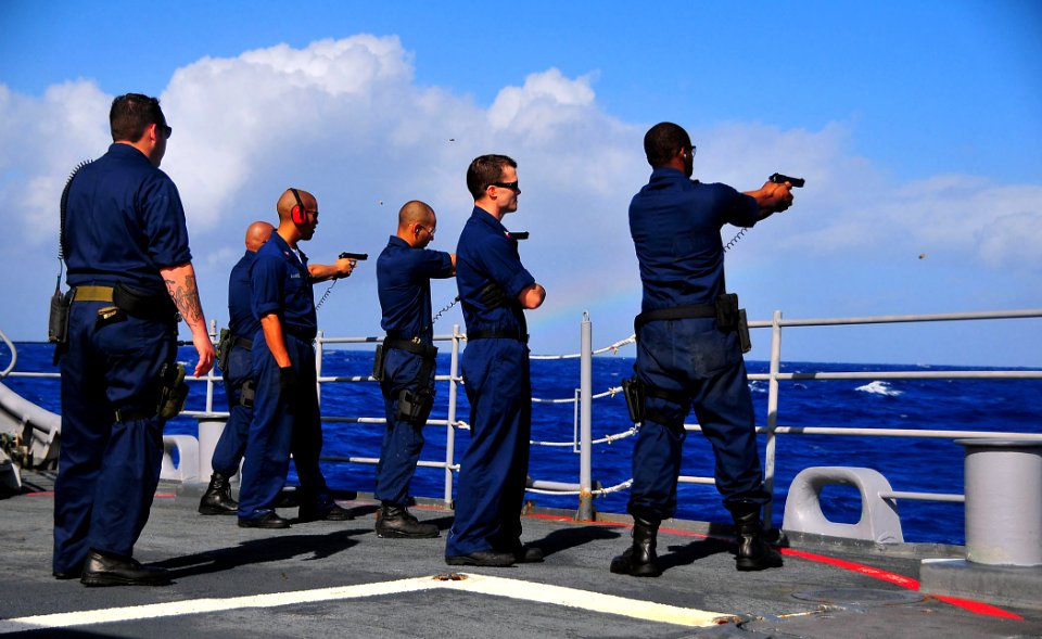 US Navy 090128-N-4774B-025 Sailors fire the Beretta M9 9mm pistol during live-fire training