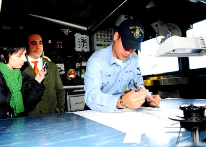 US Navy 090127-N-9552I-003 Quartermaster 3rd Class Justin Lewis explains to local Italian media how to chart a course