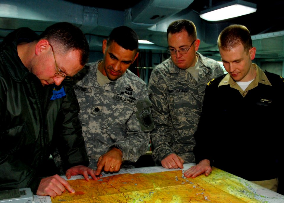 US Navy 090130-N-4044H-042 Service members from various branches of the U.S. military embarked aboard the amphibious command ship USS Mount Whitney (LCC 20) review a tactical pilot chart during the planning phase of Austere Cha