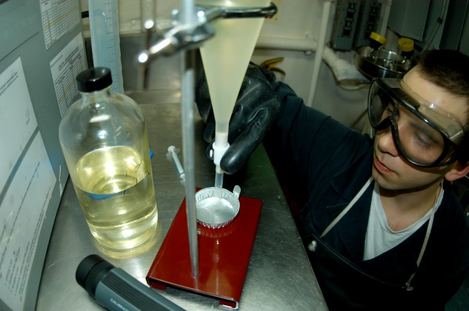 US Navy 090203-N-6692A-017 Engineman 3rd Class Kenneth Fechtner tests fuel to determine the amount of required anti-icing additive