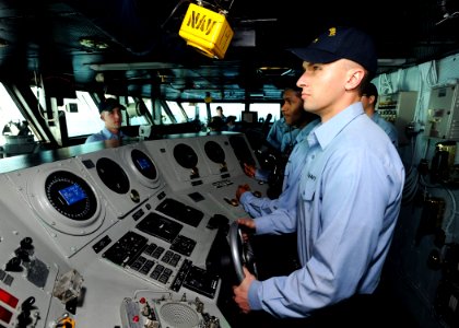 US Navy 090131-N-2908M-001 Boatswain Mate Seaman Ronald Finch stands lee helmsman watch on the bridge of the aircraft carrier USS Theodore Roosevelt (CVN 71)