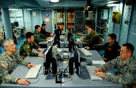 US Navy 090130-N-4044H-032 A multi-service planning team embarked aboard the amphibious command ship USS Mount Whitney (LCC 20) prepare their portion of the planning phase of Austere Challenge 2009