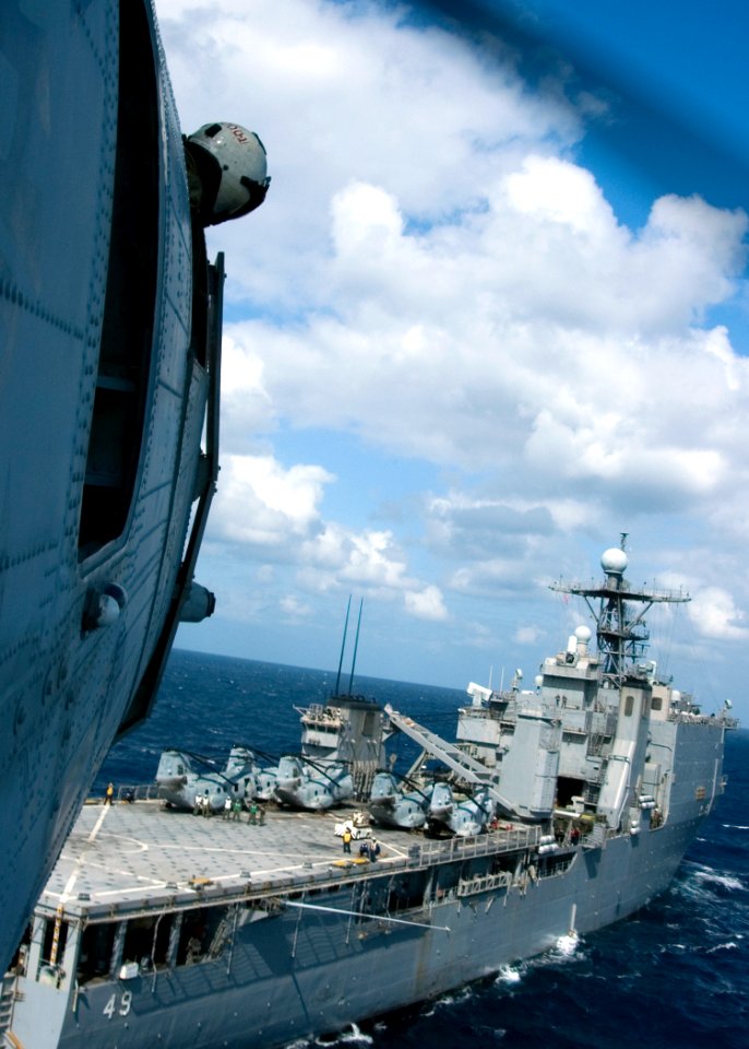 US Navy 090131-N-1251W-105 Crew Chief Pfc. Rolf Zelonis, from Vallejo, Ca., watches the flight deck of the dock landing ship USS Harpers Ferry (LSD 50) from his CH-46E Sea Knight helicopter