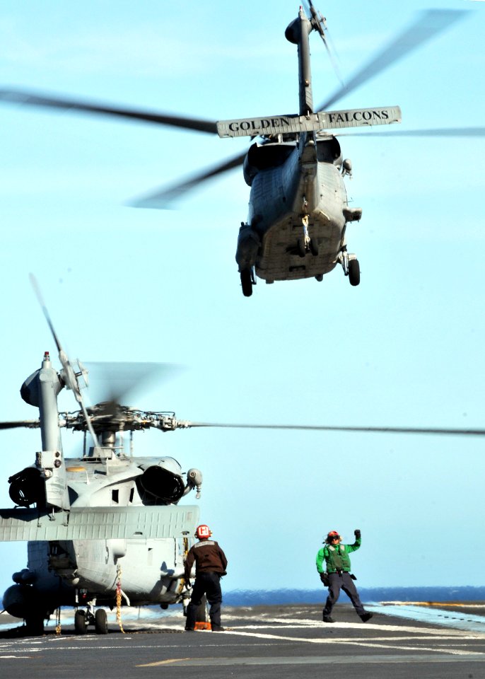US Navy 090128-N-7981E-027 An HH-60 Sea Hawk helicopter and an SH-60F Sea Hawk helicopter are launched from the aircraft carrier USS Abraham Lincoln (CVN 72)