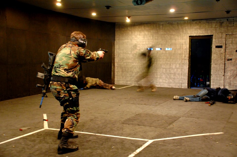 US Navy 090204-N-5366K-020 Special Warfare Operator 1st Class (SEAL) Zack Schaffer, an advanced training instructor, engages targets during a close quarters defense hooded-box drill at Naval Special Warfare Advanced Training Co