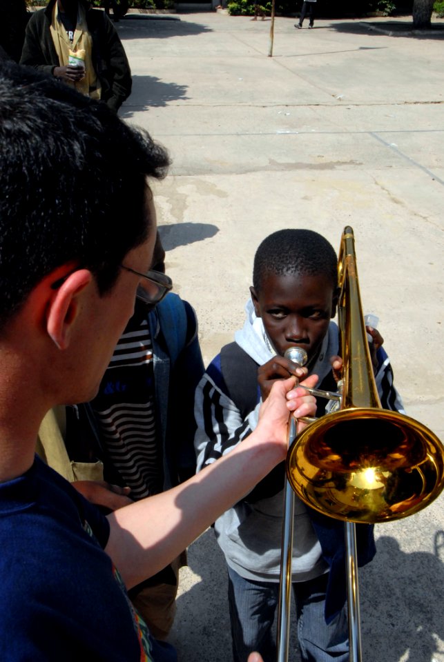US Navy 090204-N-1688B-437 Musician 1st Class Duke Stuble lets students of Lycee Abdoulaye take turns learning about different musical instruments