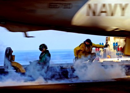 US Navy 090131-N-7571S-005 Lt. Cmdr. Pomponio, right, signals an aircraft to launch from the aircraft carrier USS Theodore Roosevelt (CVN 71)