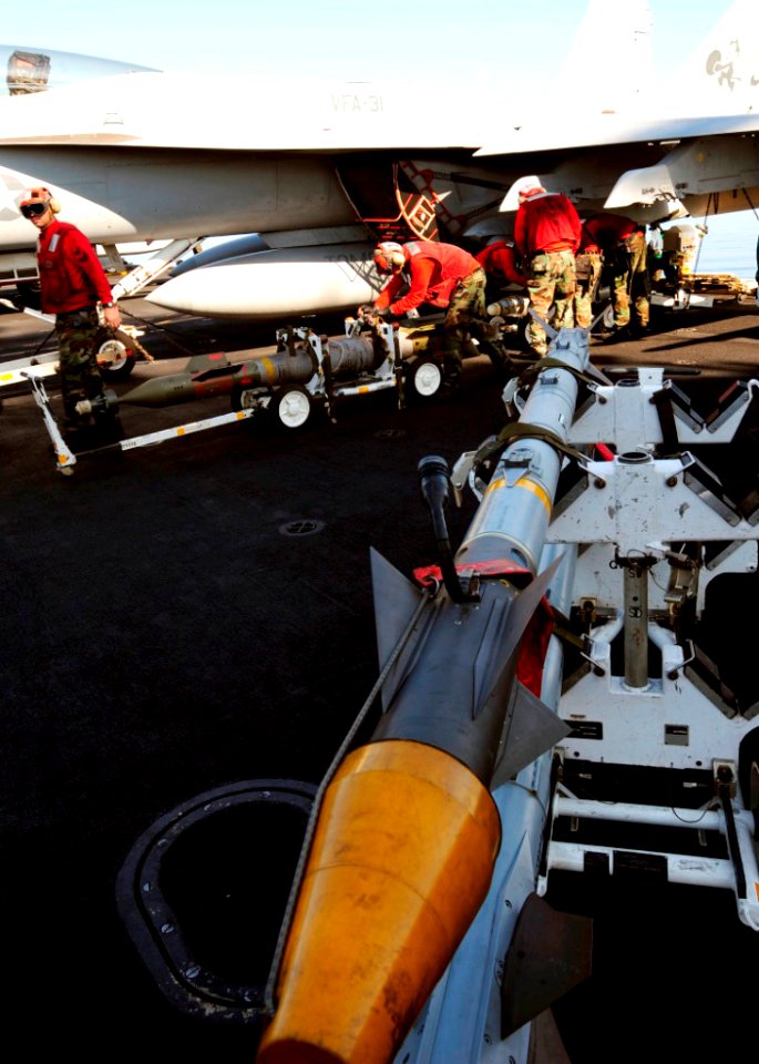 US Navy 090201-N-8822R-033 Aviation ordnancemen unload ordnance from an F-A-18E Super Hornet assigned to the