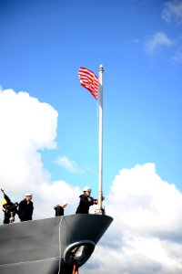 US Navy 111101-N-XR557-060 A Sailor assigned to the guided-missile cruiser USS Monterey (CG 61) raises the Union Jack on the flagstaff as the ship