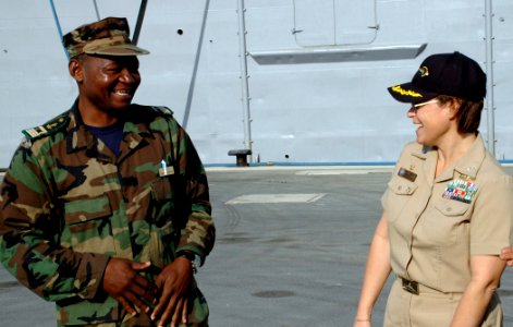 US Navy 090205-N-1655H-284 Cameroon Navy Lt. Cmdr. Clement Fru Fon and Capt. Cynthia Thebaud share a laugh in front of SS Nashvile (LPD 13)