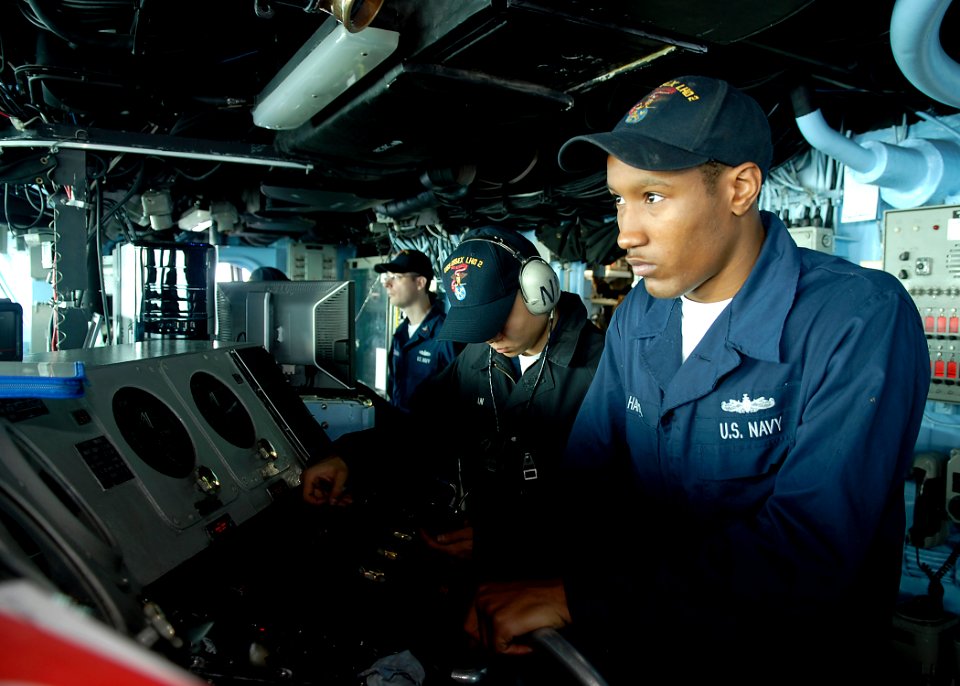 US Navy 090129-N-9520G-018 Boatswain's Mate Seaman Kevin Harris, from Drew, Miss., stands watch on the helm aboard the amphibious assault ship USS Essex (LHD 2)