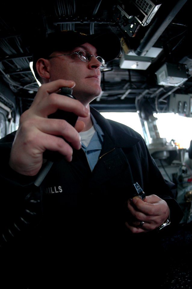 US Navy 090203-N-1512O-021 Boatswain's Mate 2nd Class Thomas Mills makes an announcement on the ship's general announcing system