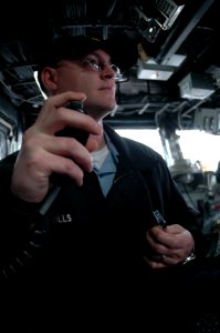 US Navy 090203-N-1512O-021 Boatswain's Mate 2nd Class Thomas Mills makes an announcement on the ship's general announcing system