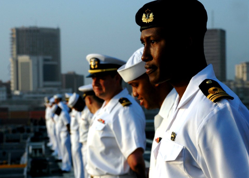 US Navy 090204-N-1655H-077 Ghana Navy Lt. Cmdr. James Agambiere mans the rails aboard the flight deck of the amphibious transport dock ship USS Nashville (LPD 13)
