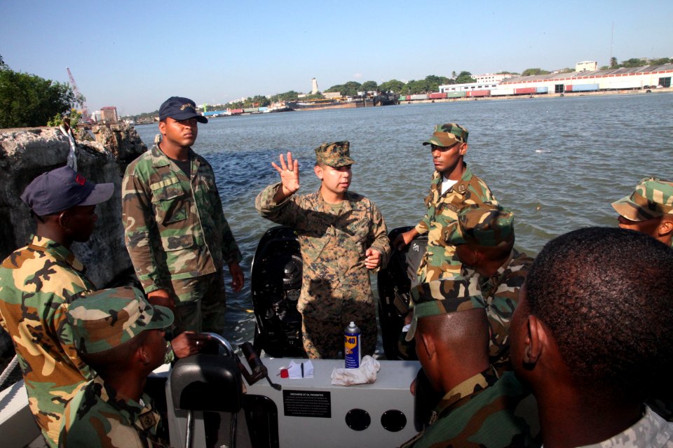 US Navy 111111-A-IP644-273 Cpl. Luis Castillo works with a Dominican sailor on small boat maintenance