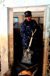 US Navy 111120-N-WV964-160 Gunner's Mate 2nd Class Charlie Harper, assigned to the guided-missile destroyer USS Lassen (DDG 82), removes sludge and