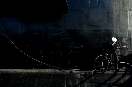 US Navy 090204-N-8467N-005 Electronics Technician 3rd Class Grant Peterson works to untangle the shore phone cable