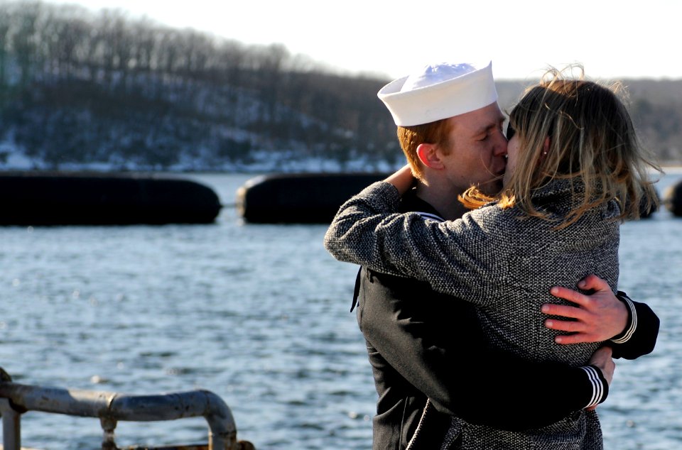US Navy 090204-N-8467N-003 lectronics Technician 2nd Class Jordan Shenton kisses his wife Erika after the boat's return to Submarine Base New London