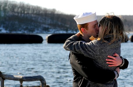 US Navy 090204-N-8467N-003 lectronics Technician 2nd Class Jordan Shenton kisses his wife Erika after the boat's return to Submarine Base New London
