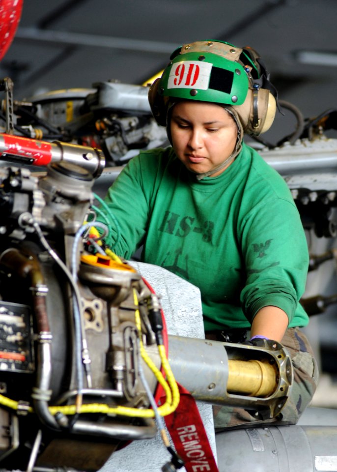 US Navy 090204-N-2562S-003 Aviation Machinist's Mate 1st Class Sandra Lay helps guide a hydro mechanical unit of an HH60-H Sea Hawk