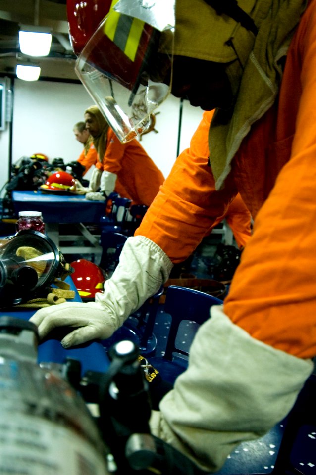 US Navy 090202-N-1251W-004 Culinary Specialist Seaman Jermaine Jefferson braces for shock during a general quarters drill aboard the amphibious dock landing ship USS Harpers Ferry (LSD 49)
