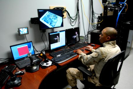 US Navy 090204-N-7676W-115 Marine Corps Sgt. Michael Steele monitors virtual scenarios from the control room of the Gruntworks Research for Infantry Integration Testing photo