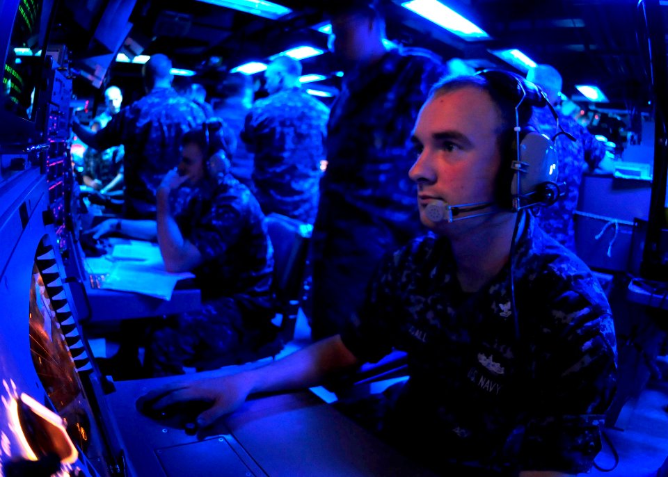 US Navy 111025-N-WJ771-189 Fire Controlman 2nd Class Stephen M. Woodall monitors a radar console in the combat information center of the forward-de