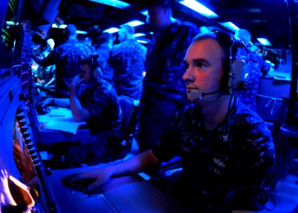US Navy 111025-N-WJ771-189 Fire Controlman 2nd Class Stephen M. Woodall monitors a radar console in the combat information center of the forward-de