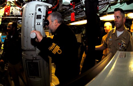 US Navy 090204-N-7705S-017 Vice Adm. Giuseppe Lertora, Commander in Chief of the Italian Fleet, peers through the periscope of the Los Angeles-class attack submarine USS Jacksonville (SSN 699) photo