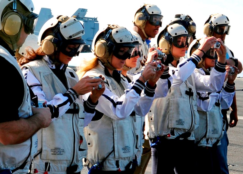 US Navy 090201-N-8822R-034 Players and cheerleaders from the NFL football team the New England Patriots observe flight operations aboard the aircraft carrier USS Theodore Roosevelt (CVN 71)