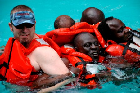 US Navy 090205-N-1655H-515 John LaFargue, a National Oceanic and Atmospheric Administration Fisheries logistical trainer conducts water survival training with Senegalese marine biologists during an Africa Partnership Station tr photo
