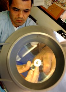 US Navy 090203-N-6326B-028 Hospital Corpsman 2nd Class Daniel Cortez, a maxillofacial prosthetics laboratory technician at Naval Medical Center, San Diego, polishes a prosthetic eye