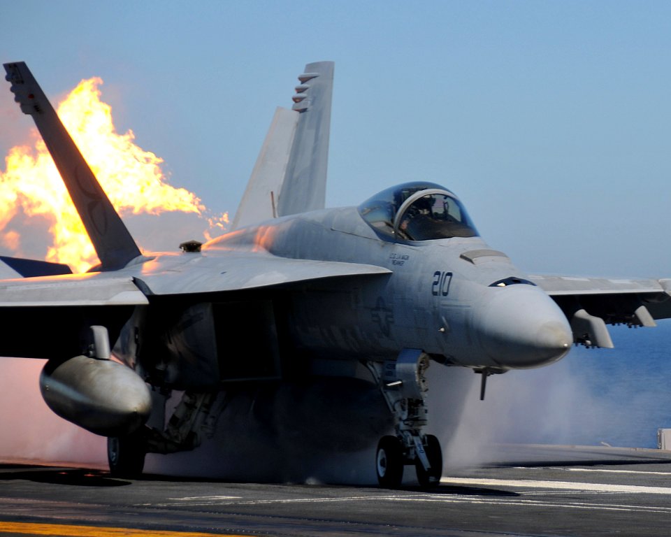 US Navy 090202-N-7981E-138 An F-A-18E Super Hornet belts fire as it launches from USS Abraham Lincoln (CVN 72)