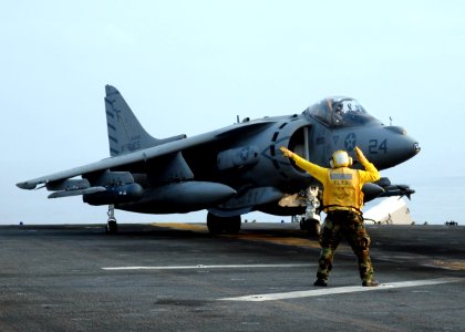 US Navy 090206-N-9520G-073 A Sailor directs an AV-8B Harrier II during flight operations aboard the amphibious assault ship USS Essex (LHD 2)
