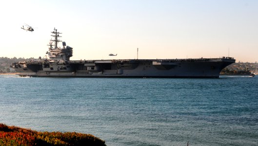 US Navy 111103-N-KB563-095 SH-60S Sea Hawk helicopters fly above the aircraft carrier USS Ronald Reagan (CVN 76) as it returns to homeport