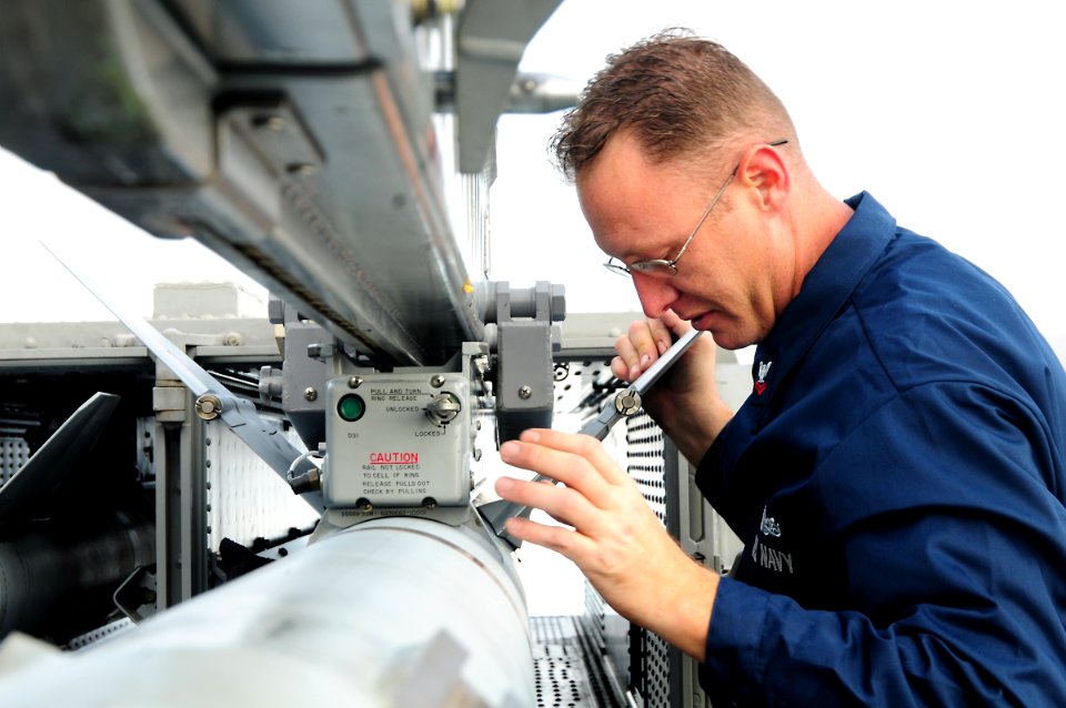 US Navy 111117-N-FH966-032 A Sailor inspects wing of aircraft
